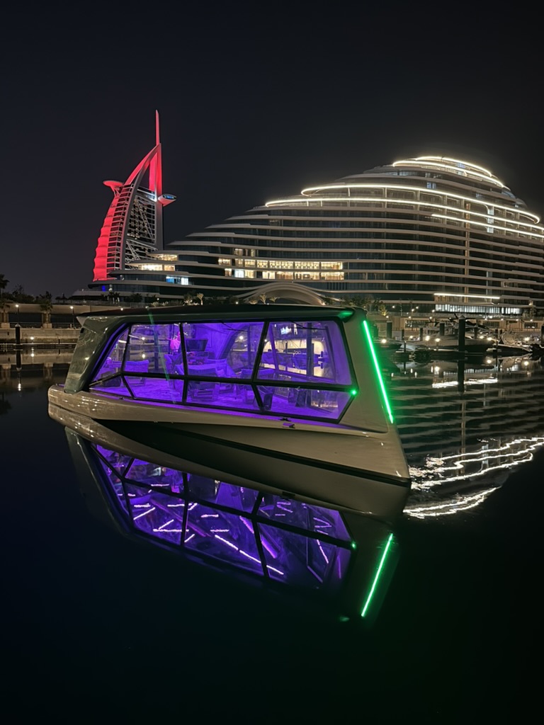 THE ICON and its reflection in a Dubai marina at night