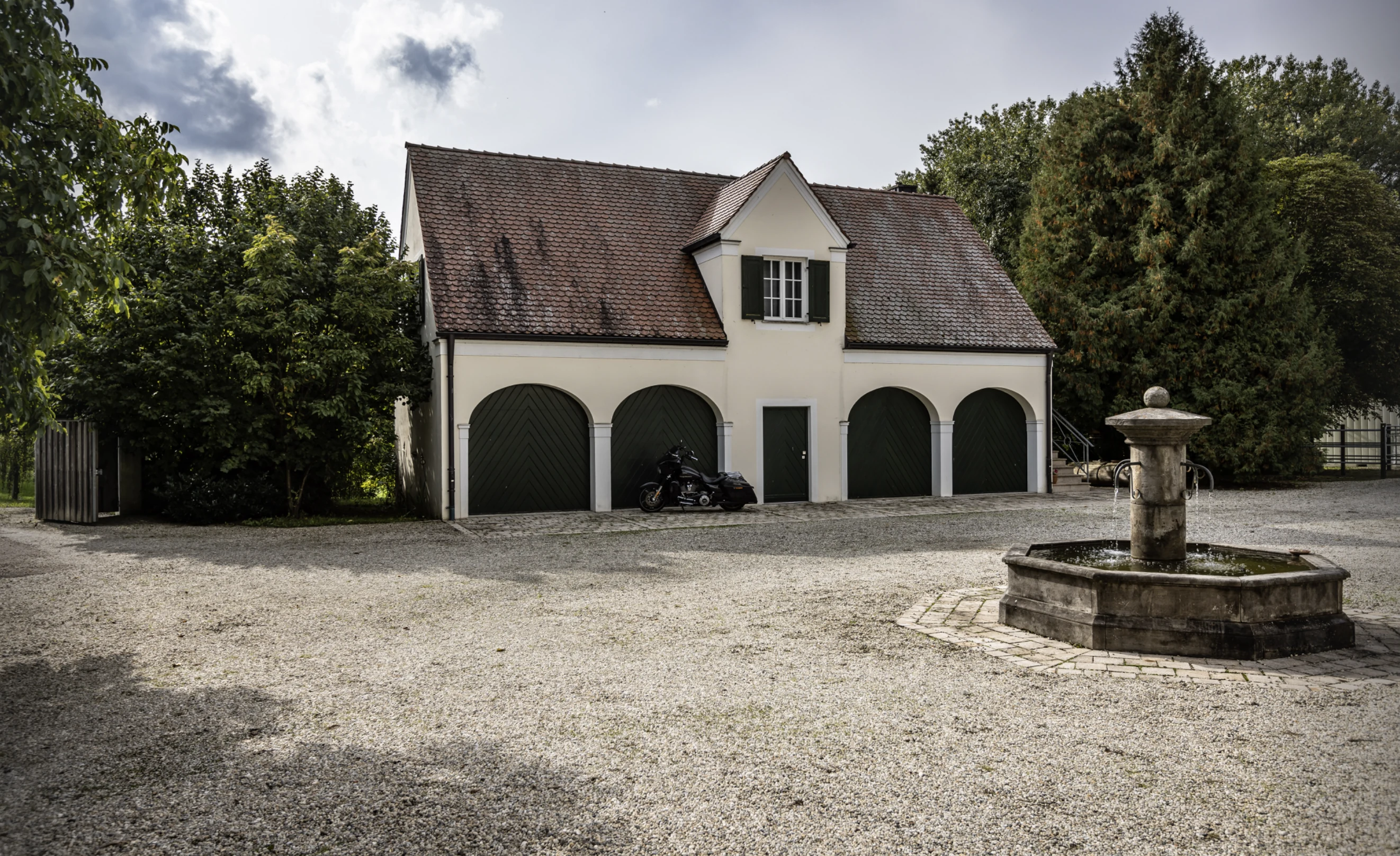 Outbuilding, garages, and courtyard fountain